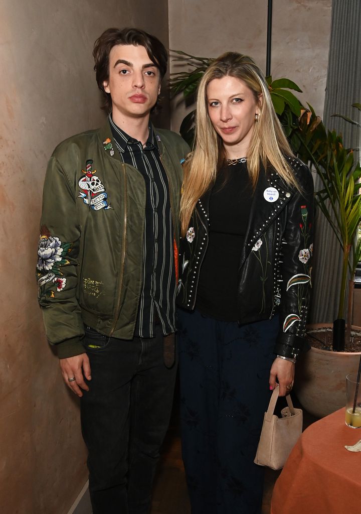 Sascha Bailey (L)and Lucy Brown wear matching embroidered jackets, one a green bomber and the other a studded black leather jacket, at a Chelsea Flower Show event