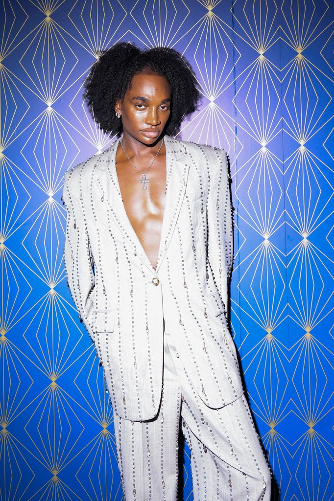 Rickey Thompson wears a shirtless silver suit embellished with crystals and layered jewelry at the Met Gala 2025 after-party.
