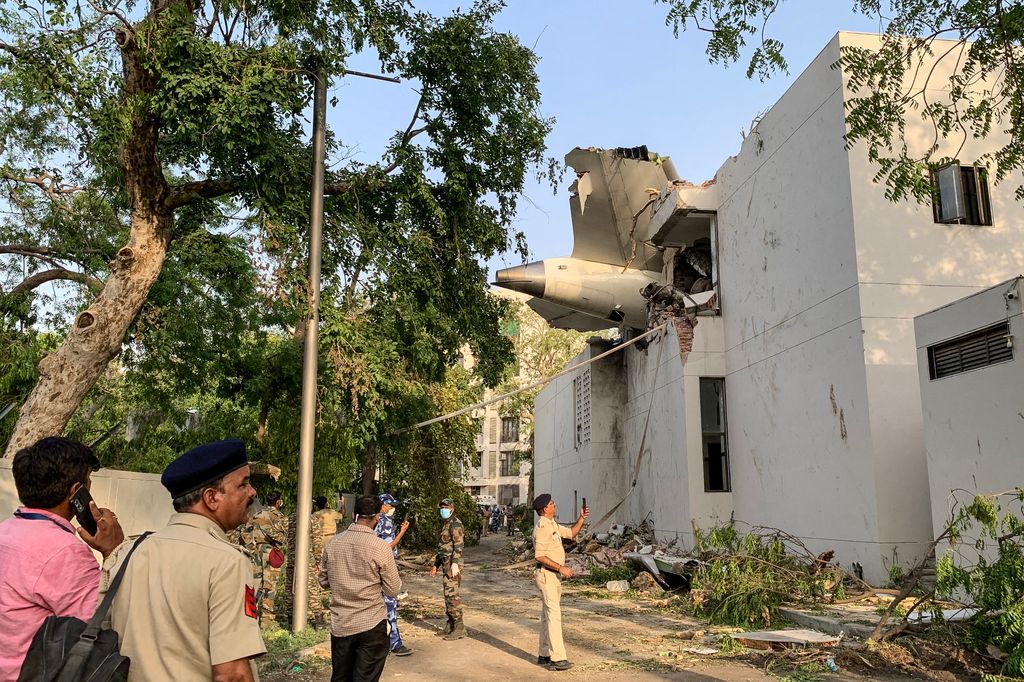TOPSHOT - The back of Air India flight 171 is pictured at the site after it crashed in a residential area near the airport in Ahmedabad on June 12, 2025. A London-bound passenger plane crashed in the Indian city of Ahmedabad on June 12 and all 242 people on board were believed killed, with the jet smashing into buildings housing doctors and their families. (Photo by Sam PANTHAKY / AFP) (Photo by SAM PANTHAKY/AFP via Getty Images)          