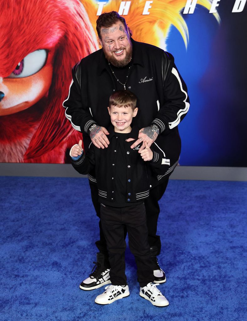 Jelly Roll with his son premiere matching black jackets