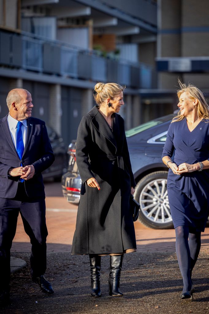 Queen Maxima arriving in black coat and boots