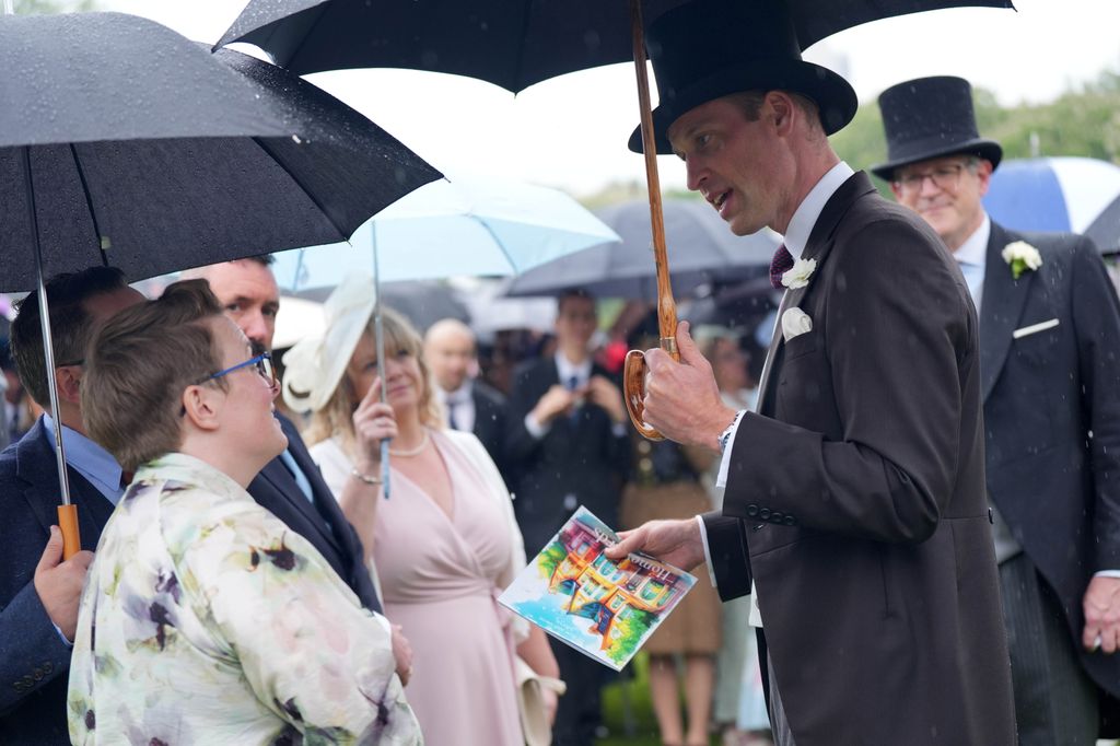Prince William receives artwork from guest at garden party