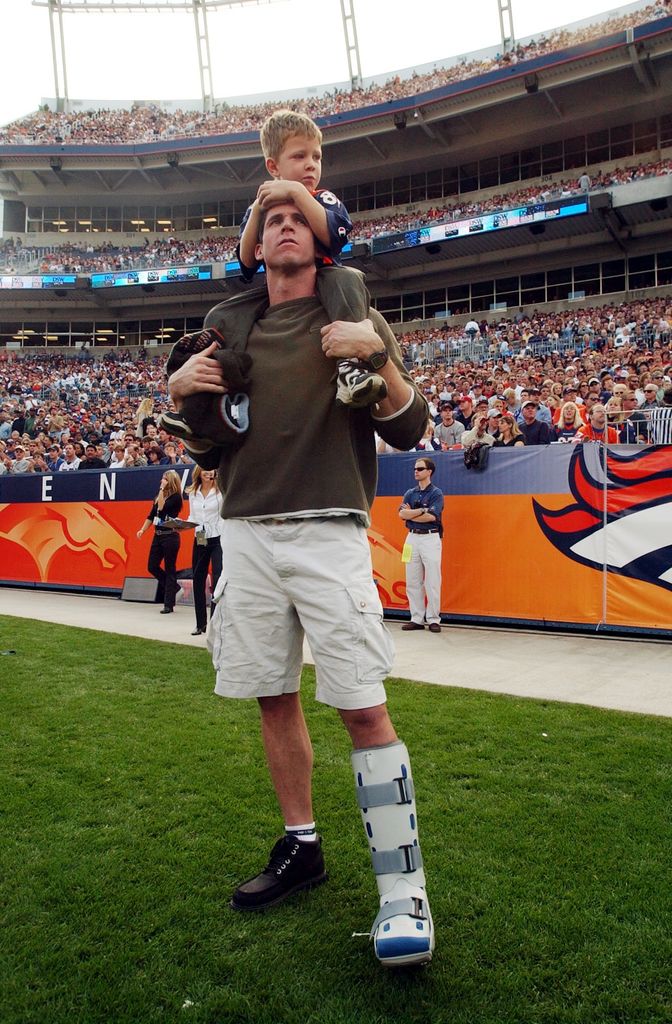 Ed McCaffrey and his son Christian watch first quarter action from the sideline during the Denver Broncos 31-20 victory over the New England Patriots, 10/28/01