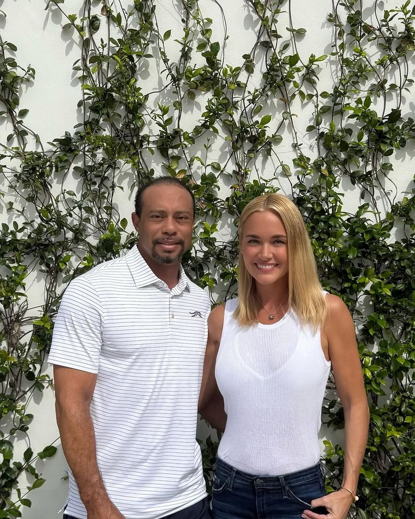 Tiger Woods and Vanessa Trump posing together in white