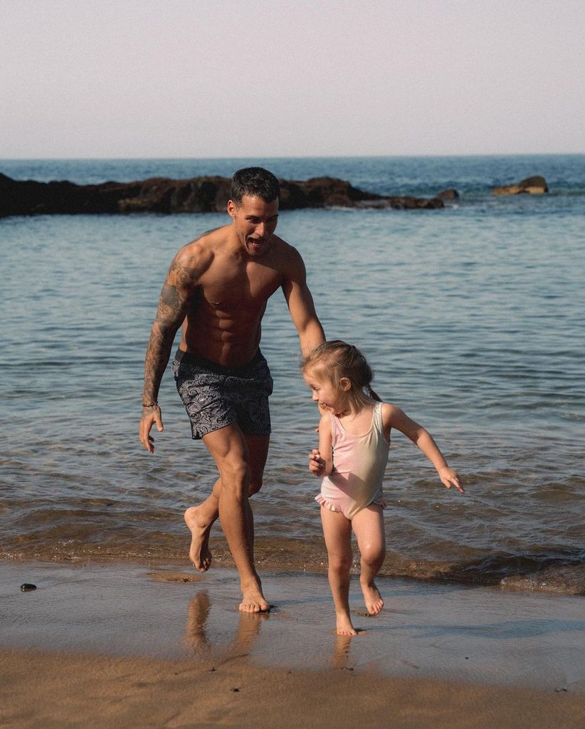 Gorka playing on the beach with his daughter Mia