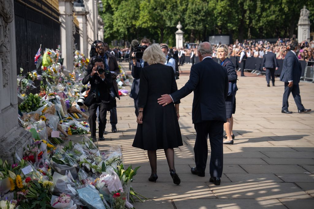 King Charles supports Queen Camilla as they view floral tributes for Queen Elizabeth II outside Buckingham Palace