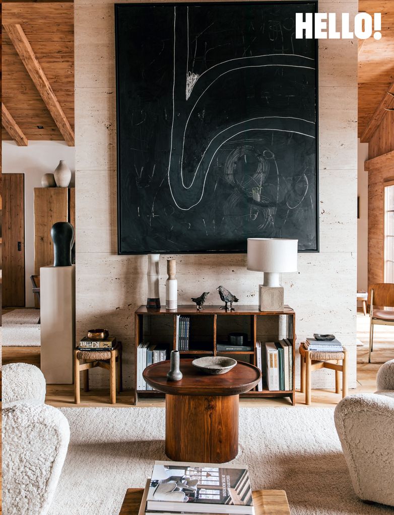 A large canvas on the wall in the double-height living room in the swiss chalet 