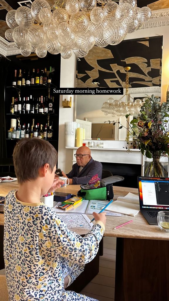 Wolfie at table drawing in lavish room