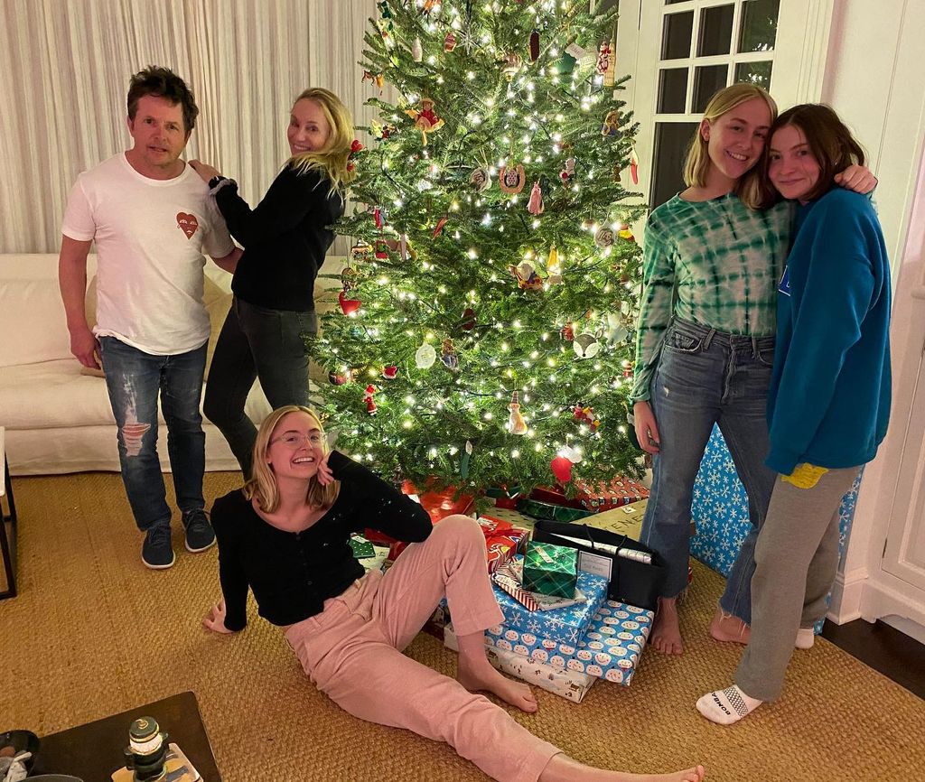 Michael j fox with wife and kids by christmas tree