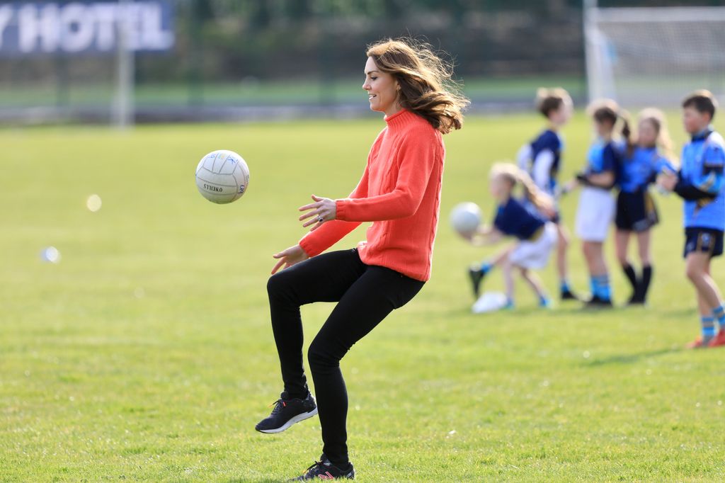 Princess Kate kicking a ball in the air