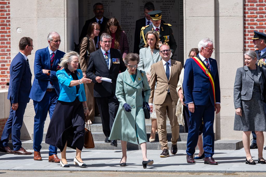 princess anne in green coat dress surrounded by people