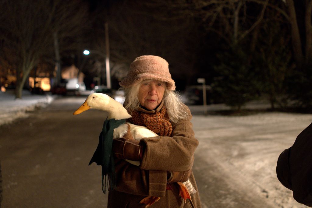 Claire Coulter holding a duck in a scene from Three Pines