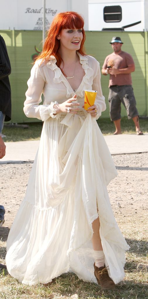 Florence Welch is seen at Glastonbury in 2010 wearing a sheer ruffled white dress 