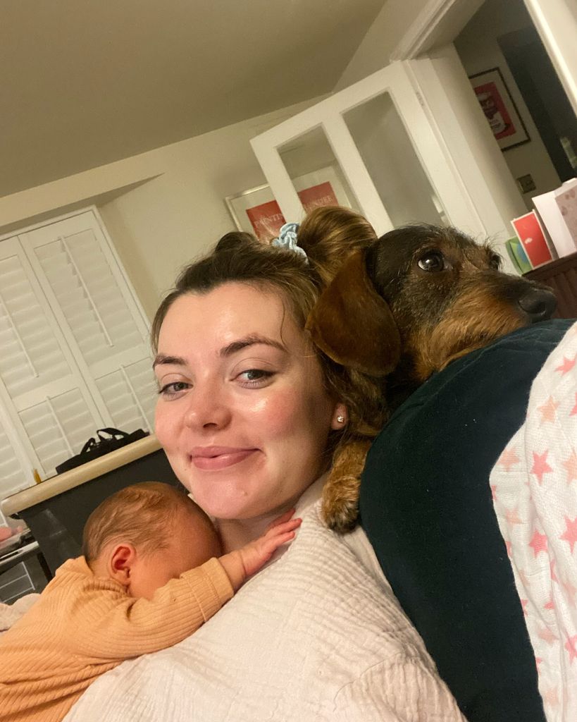 Rosie also shared a sweet photo with her dog Ruby as she cradled he new born