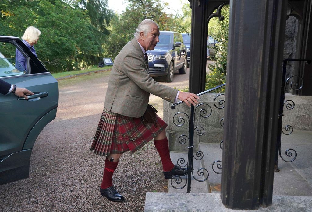 King Charles going up the stairs to attend church in Balmoral