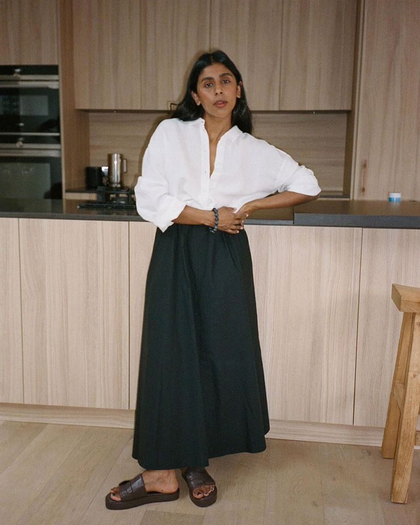 Influencer MonikH wearing a white shirt and full skirt