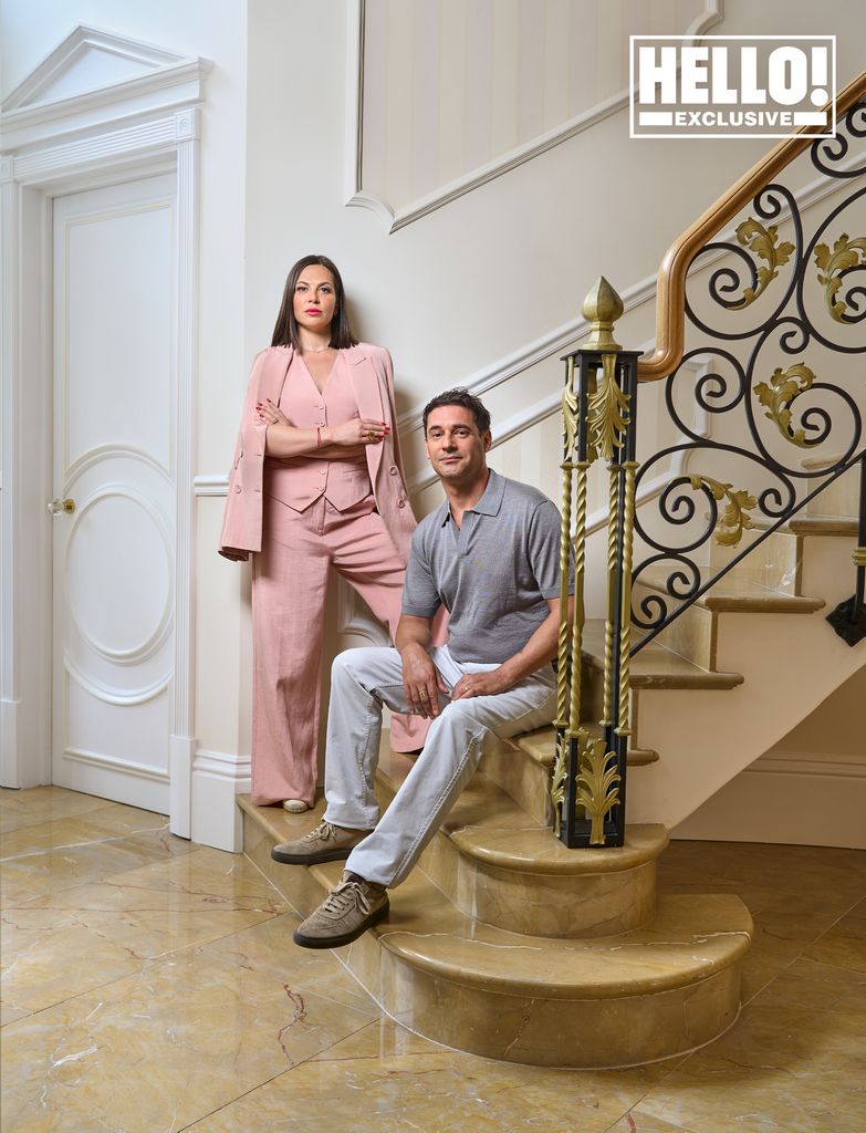 Pierre and Lilia Mascolo posing on marble staircase at grand entrance at Surrey home Summerdown Manor