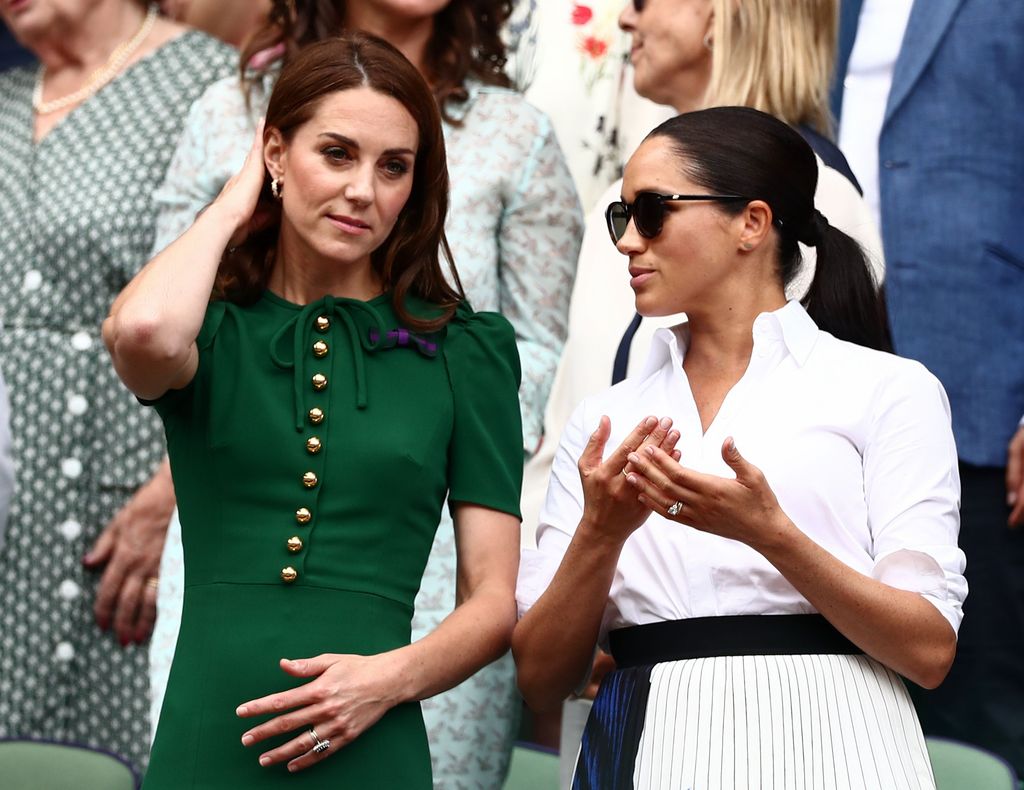Kate Middleton and Meghan Markle talking in the Royal Box