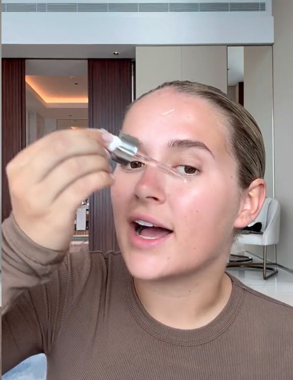 Molly-Mae applying L'Oreal serum