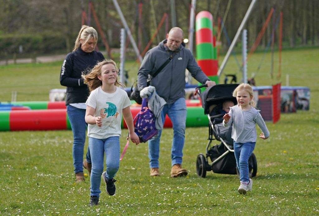 Mike Tindall on grass with his children Mia (left), Lena Elizabeth (right) and Lucas at the Barefoot Retreats Burnham Market International Horse Trials