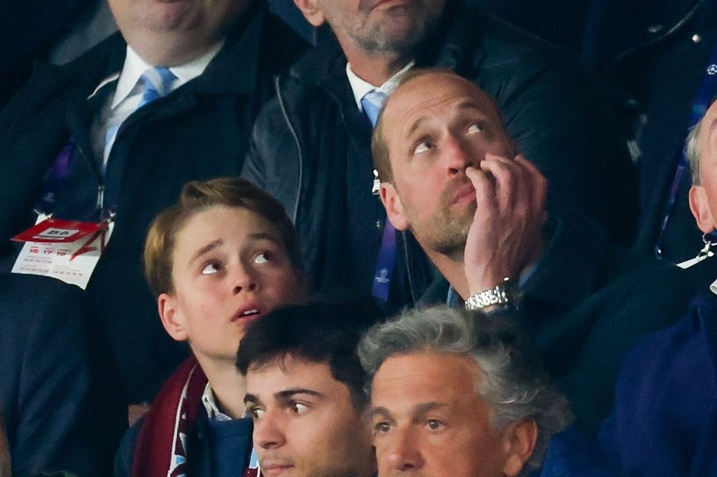 George and William look up at score at Villa match