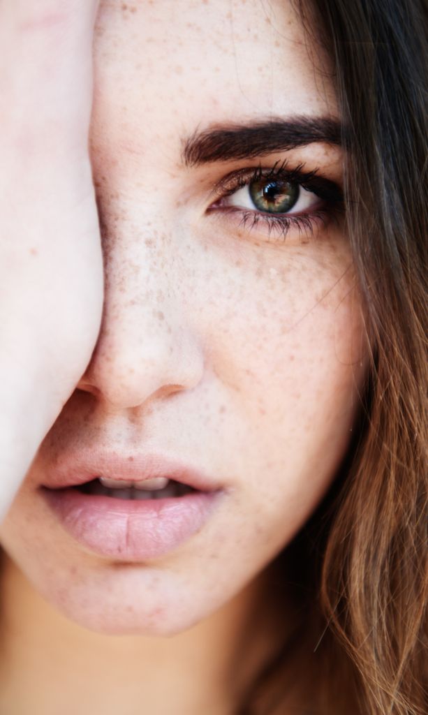 Model holding her hand over one side of her face