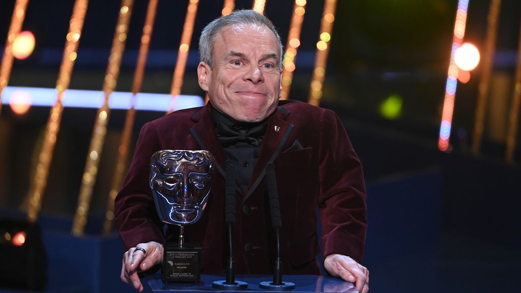 Warwick Davis on stage at the BAFTAs 