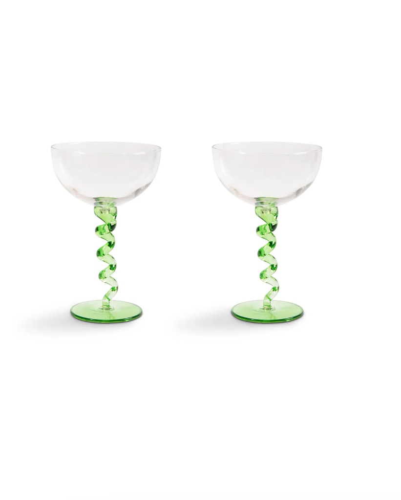 A set of two swirly wine glasses in a green