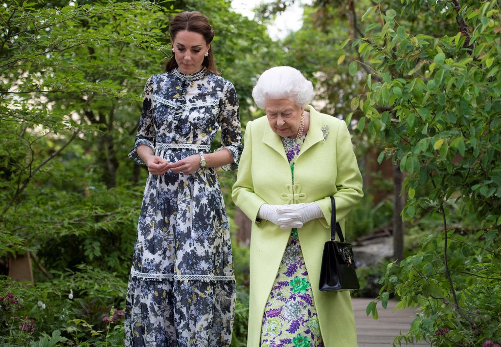 Britain's Catherine, Duchess of Cambridge (L) shows Britain's Queen Elizabeth II and Britain's Prince William, Duke of Cambridge, around the 'Back to Nature Garden' garden