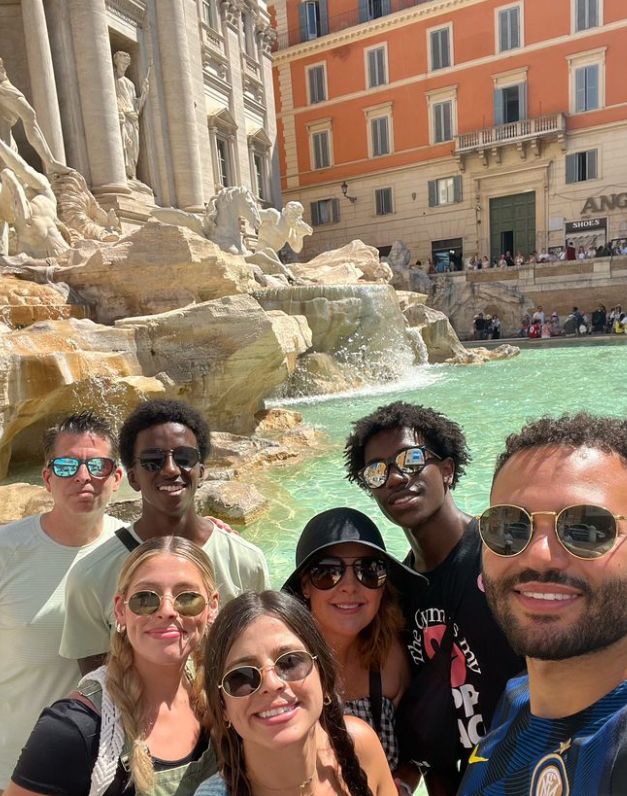 Julie Neal with her husband and five children in front of a fountain