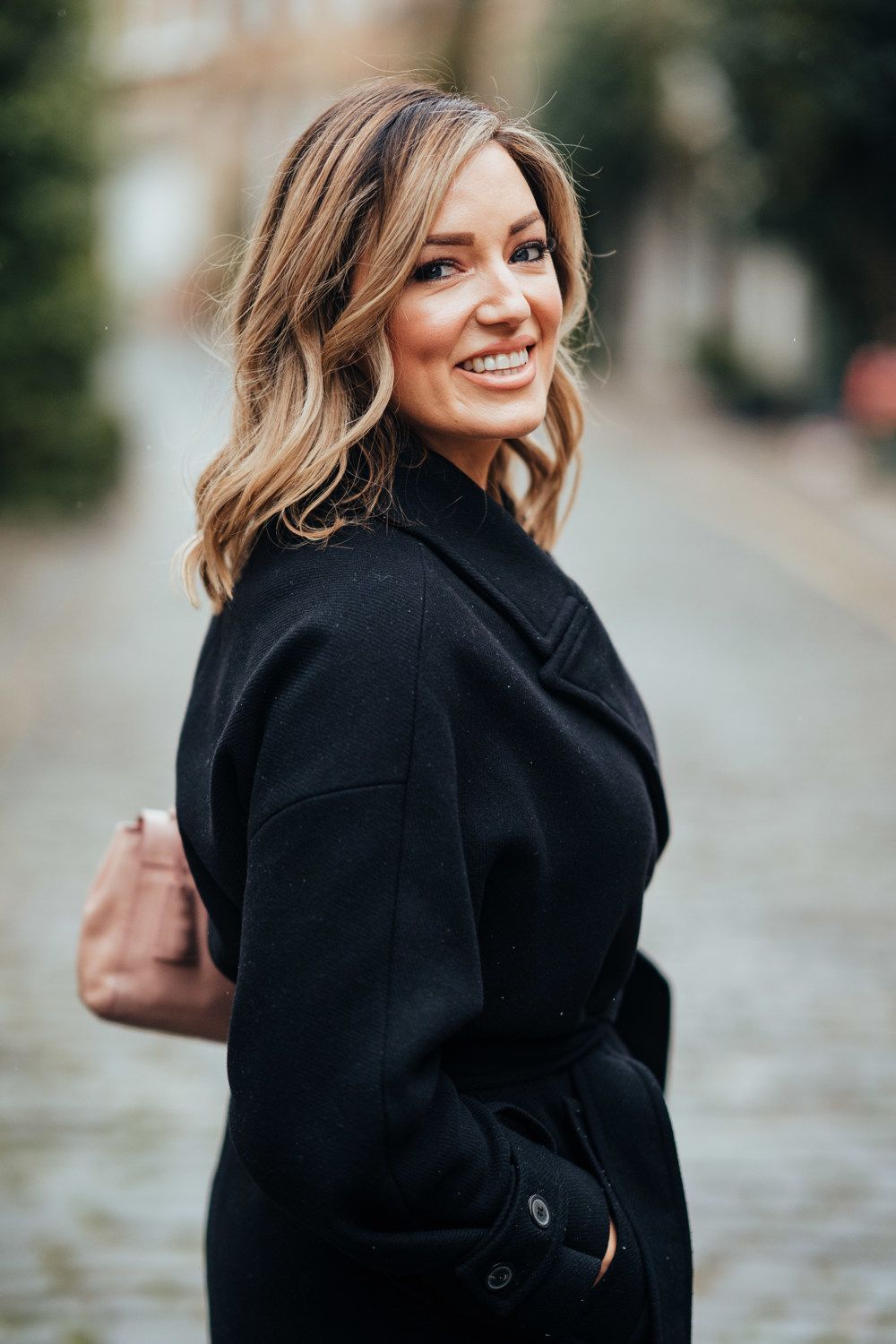 Beautiful woman smiling in a black coat