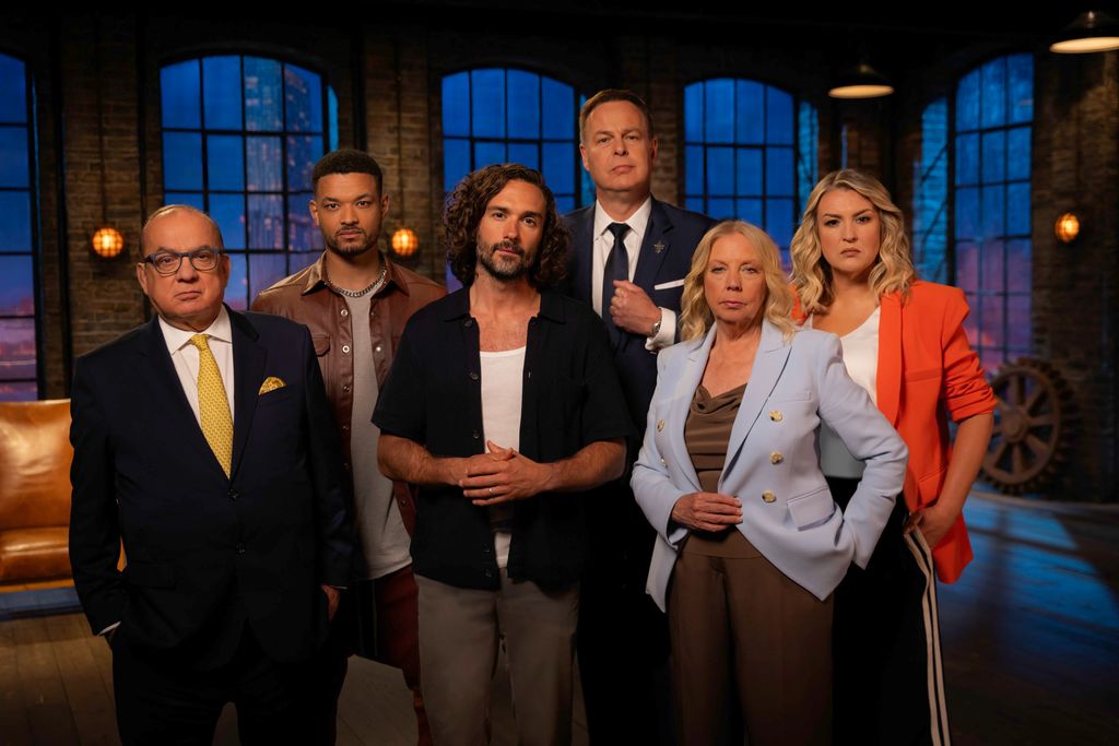 Joe Wicks standing in the middle of Touker Suleyman, Steven Bartlett, Peter Jones, Deborah Meaden and Sara Davies