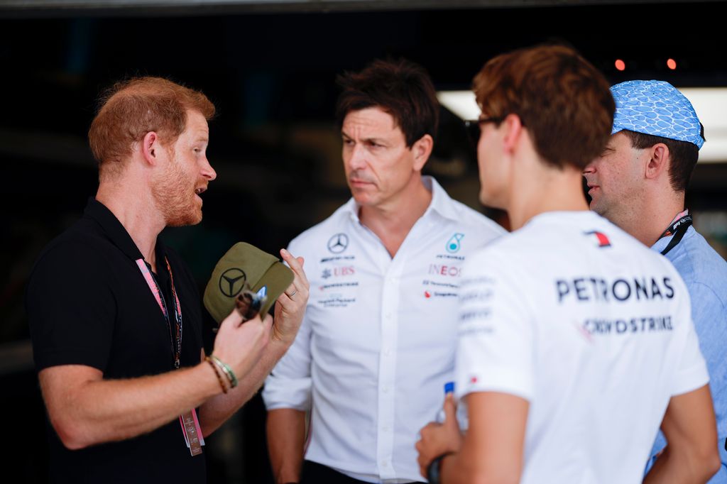 Prince Harry, Duke of Sussex speaks to Mercedes GP Executive Director Toto Wolff 
