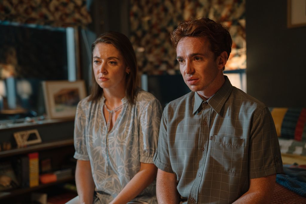 woman and man sitting on bed edge