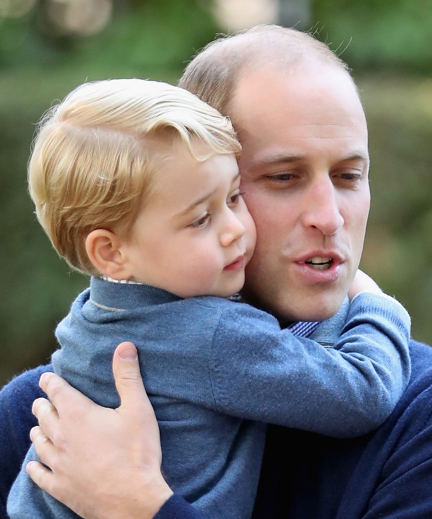 The Prince of Wales hugging Prince George