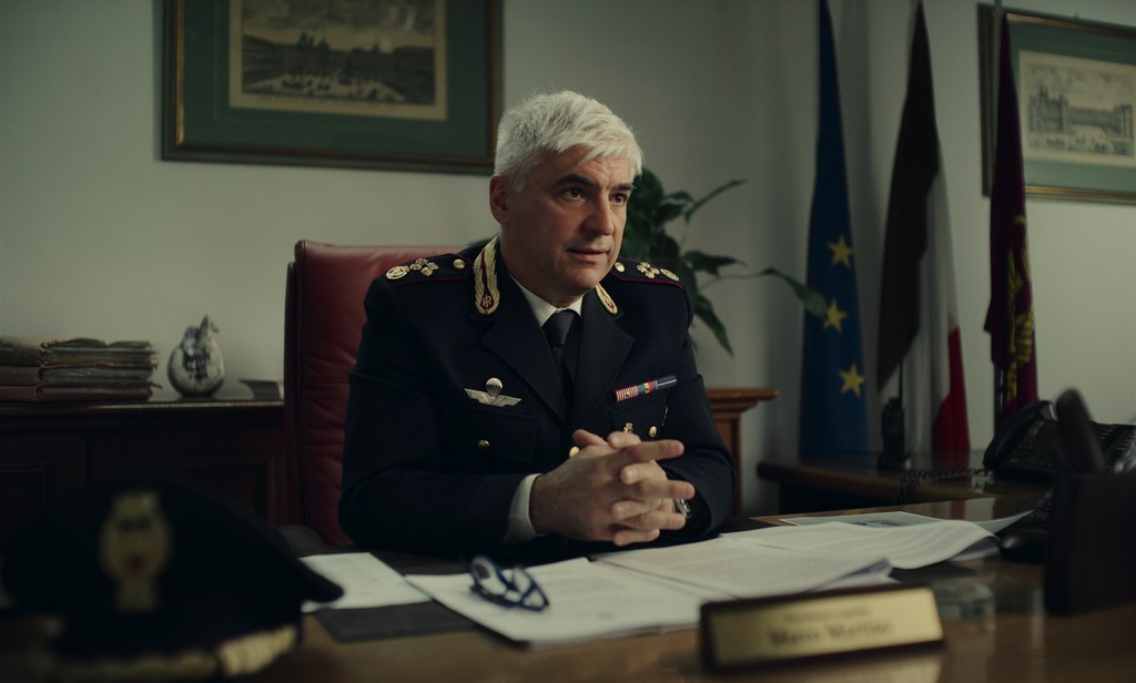 A policeman sits behind a desk