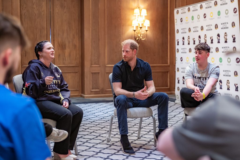 Prince Harry sat in a circle with a group of young people