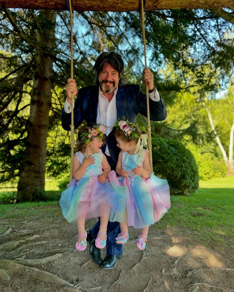 Laurence Llewelyn-Bowen in garden of Cotswolds home with granddaughters