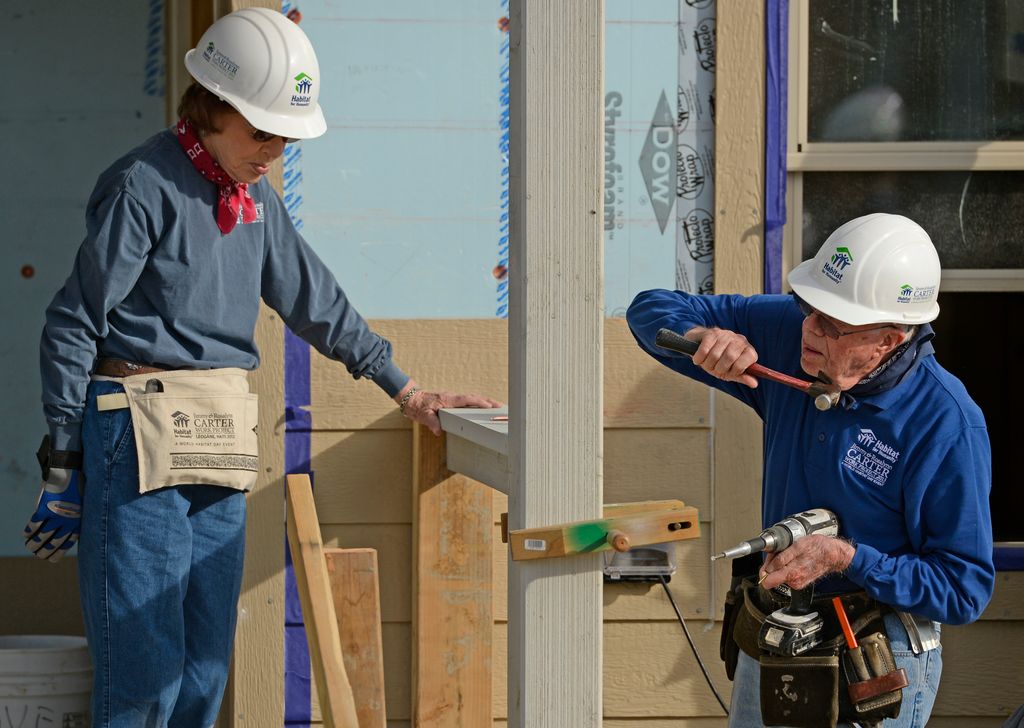 Former president Jimmy Carter and his wife, Rosalynn, work on building a home during Habitat for Humanity's Carter Work Project event in the Globeville Neighborhood in Denver, October 09, 2013