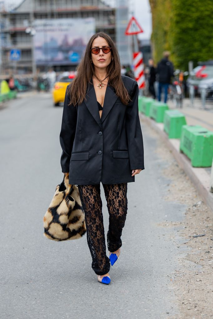 Idalia Salsamendi wears black oversized blazer, laced pants, animal print bag outside Munthe during the Copenhagen Fashion Week Spring/Summer 2024 on August 10, 2023 in Copenhagen, Denmark. (Photo by Christian Vierig/Getty Images)