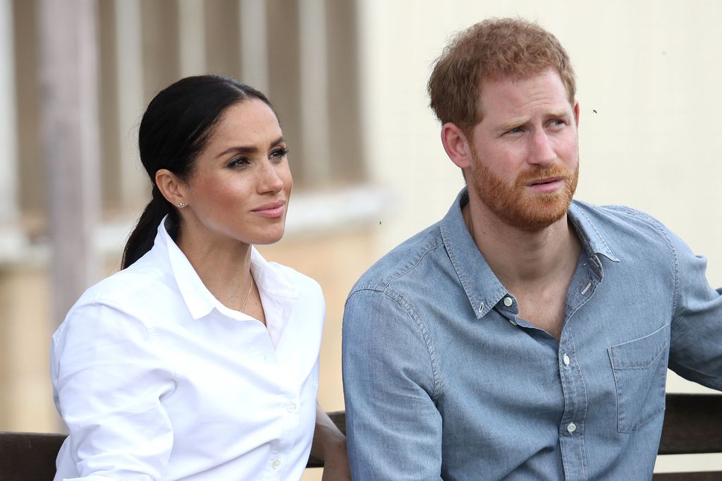 Prince Harry and Meghan Markle looking serious 