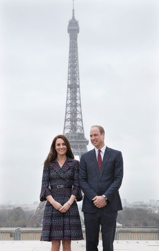 couple posing in front of eiffel tower