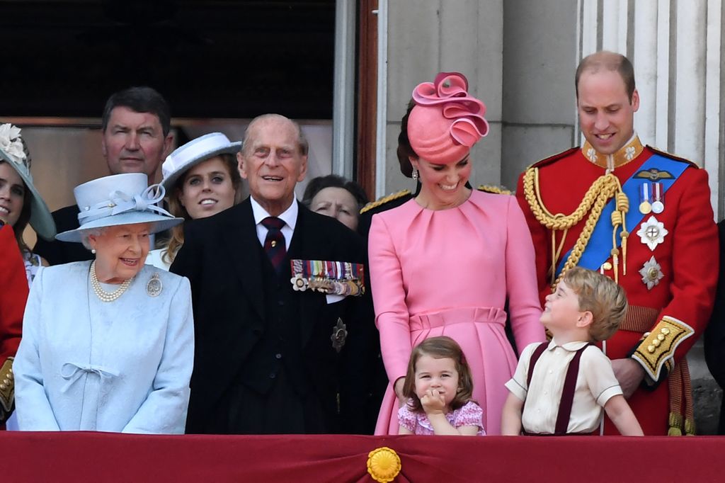 Britain's Queen Elizabeth II, Vice Admiral Timothy Laurence, Britain's Princess Beatrice of York, Britain's Prince Philip, Duke of Edinburgh, Britain's Catherine, Duchess of Cambridge (with Princess Charlotte and Prince George), and Britain's Prince William, Duke of Cambridge, stand on the balcony of Buckingham Palace to watch a fly-past of aircraft by the Royal Air Force, in London on June 17, 2017.