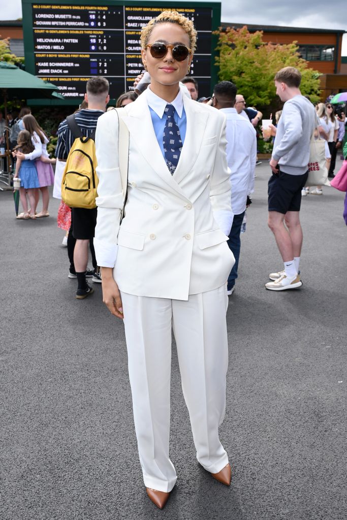 Nathalie Emmanuel dressed in off-white blazer and trouser combo