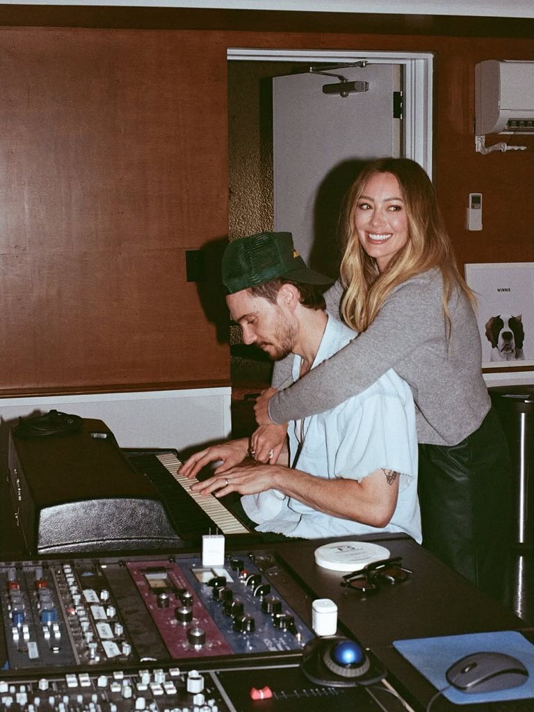 Hilary Duff arms around husband Matthew Koma in study