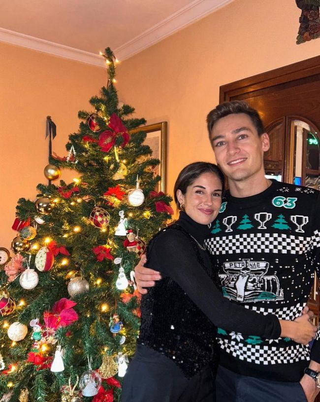 Carmen Montero Mundt hugging George Russell in front of a Christmas tree