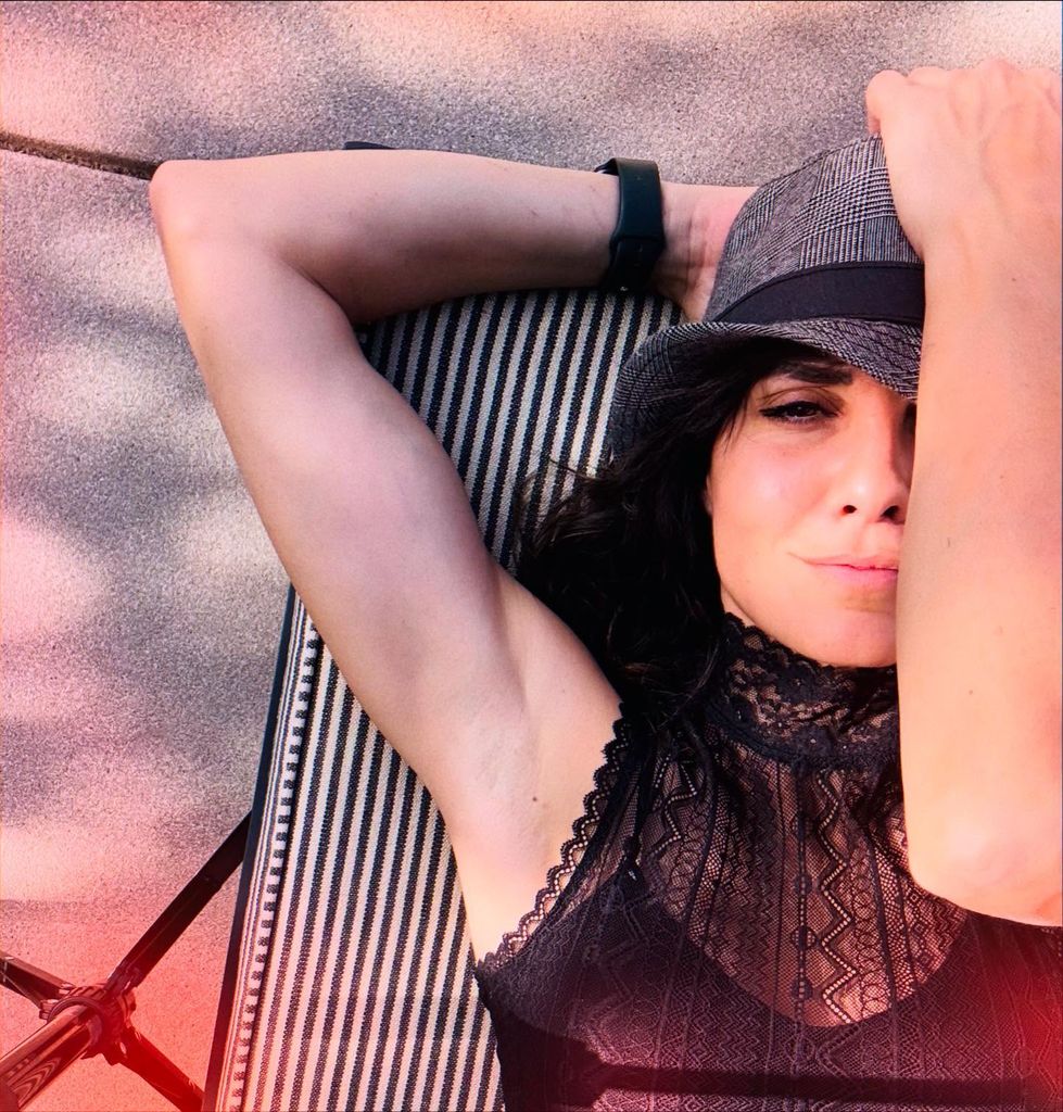 photo of daniela ruah with one arm across face