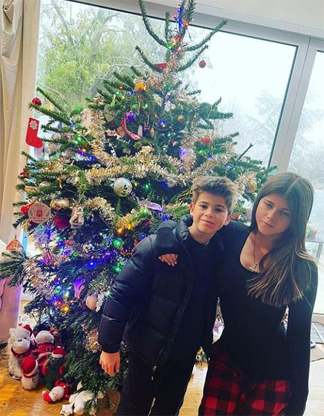 Kate Garraways son and daughter in front of a Christmas tree