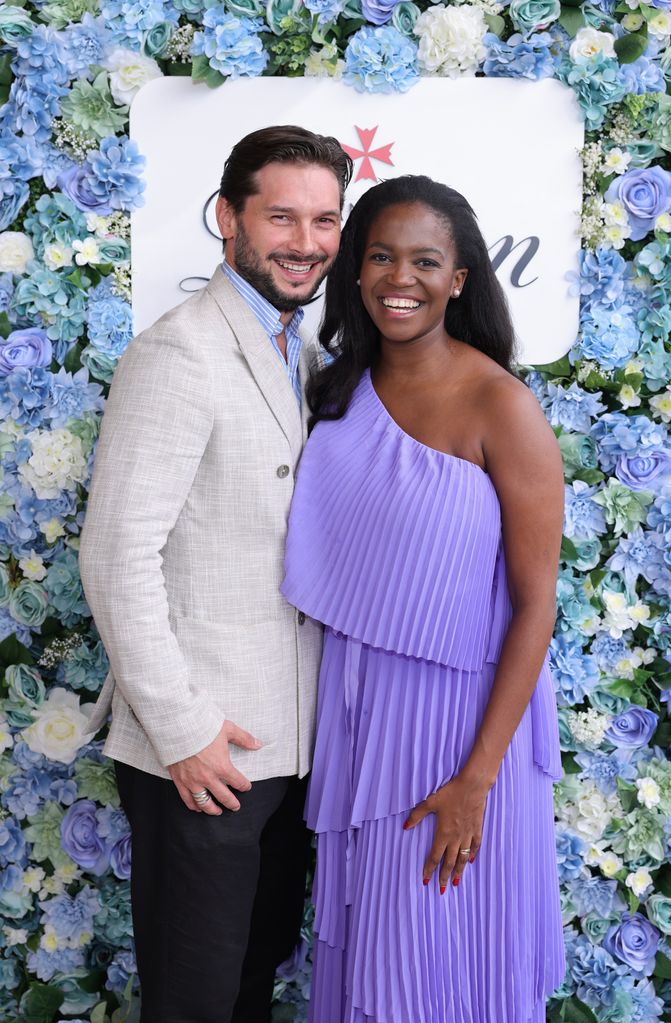 Pregnant Oti Mabuse with husband Marius Iepure posing with Champagne Lanson at The Championships at Wimbledon on