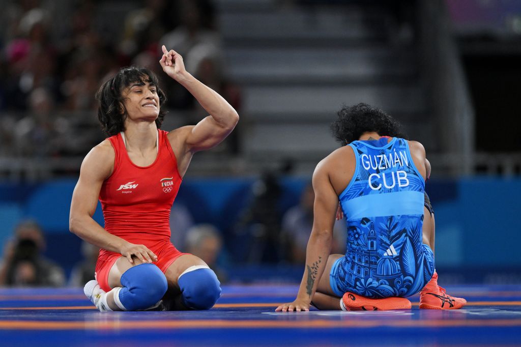 Vinesh Vinesh of Team India (red) celebrates victory against Yusneylis Guzman Lopez of Team Cuba (blue) during the Wrestling Women's Freestyle 50kg Semifinal on day eleven of the Olympic Games Paris 2024 at Champs-de-Mars Arena on August 06, 2024 in Paris, France.